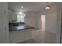 Modern kitchen with white cabinets, dark countertops, and a breakfast bar at 316 Nw Narcissus Rd, Dunnellon, FL 34431