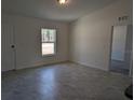 Bright and airy living room with tile floors and a view of the backyard at 316 Nw Narcissus Rd, Dunnellon, FL 34431