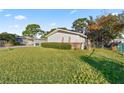 View of the home's side showcasing a large yard at 438 Spring Ln, Ocala, FL 34472