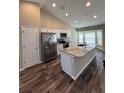 Modern kitchen with stainless steel appliances, marble countertops, and a large island featuring a sink at 6414 Sw 67Th Pl, Ocala, FL 34476