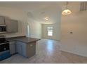 Modern kitchen with grey cabinets and stainless steel appliances at 67 Nw Sparrow Rd, Dunnellon, FL 34431