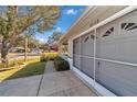 Charming home featuring a well-maintained lawn, covered porch, and a screened attached garage at 9708 Sw 97Th St, Ocala, FL 34481