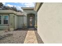 Charming front entrance with stone pathway leading to the arched doorway at 13100 Se 94Th Ave, Summerfield, FL 34491