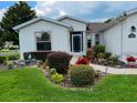 Charming home featuring a beautifully landscaped front yard with colorful flowers and healthy shrubs at 15842 Sw 11Th Terrace Rd, Ocala, FL 34473