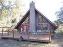 A-frame home with large windows and a deck at 17840 Se 28Th Pl, Silver Springs, FL 34488