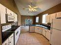 Bright kitchen with white cabinetry, a curved countertop, and modern appliances at 2352 Nw 53Rd Avenue Rd, Ocala, FL 34482