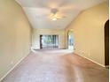 Spacious living room with high ceilings, neutral carpeting, and a view to the backyard at 2352 Nw 53Rd Avenue Rd, Ocala, FL 34482