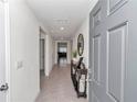 Inviting hallway with tile flooring and stylish console table, leading to the living areas of the home at 3775 Sw 127Th Lane Rd, Ocala, FL 34473