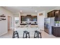 Modern kitchen with dark cabinets, granite countertops, and an island with seating at 4026 Nw 48Th Terrace Rd, Ocala, FL 34482