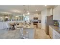 Bright kitchen and breakfast nook featuring modern cabinets, stainless steel appliances, and a large island at 4760 Nw 39Th Street Rd, Ocala, FL 34482