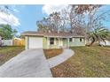 Charming single-story home featuring an attached garage, green paint, and a well-maintained front yard at 6302 Nw 57Th Ave, Ocala, FL 34482