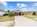 House exterior showcasing a brown garage door and a driveway at 7454 Sw 101St Ave, Ocala, FL 34481