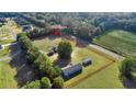 Aerial view of a 1-acre property with a house and fenced paddock at 7601 Se 22Nd Ave, Ocala, FL 34480