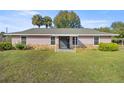 Charming one-story home featuring a pink stucco exterior and landscaping at 7601 Se 22Nd Ave, Ocala, FL 34480