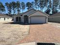 Charming one-story home with two-car garage and brick-paved driveway at 7673 Sw 180Th Cir, Dunnellon, FL 34432