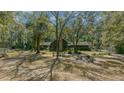 House surrounded by large trees and a spacious yard at 7740 Sw 70Th Ave, Ocala, FL 34476