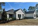 Beautiful single story home featuring manicured landscaping, a modern design, and inviting curb appeal at 8481 Sw 137 Ct, Dunnellon, FL 34432