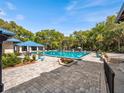 Large community pool area with shaded seating, manicured landscape, and blue pavilion at 8510 Sw 108Th Place Rd, Ocala, FL 34481