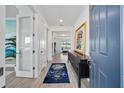 Entryway with wood-look tile, blue rug, console table, and open view to the living space at 8630 Sw 61St Loop, Ocala, FL 34481