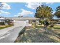 Well-maintained single-story home featuring an attached garage, covered entry, and manicured landscaping at 8707 Sw 95Th Ln # G, Ocala, FL 34481