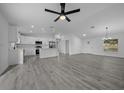 Open concept living and kitchen area with gray vinyl flooring at 9731 Bahia Rd, Ocala, FL 34472