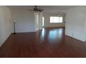 Spacious living room featuring hardwood floors and a ceiling fan at 9761 Sw 90Th St, Ocala, FL 34481