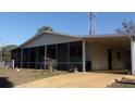Home exterior with a screened lanai and convenient carport at 10015 Sw 90Th Ct, Ocala, FL 34481