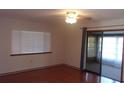 Bright living area featuring wood floors, a ceiling fan, and access to a screened lanai at 10015 Sw 90Th Ct, Ocala, FL 34481
