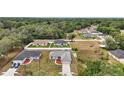 Aerial view of a neighborhood featuring well-maintained homes and landscaped yards in a serene setting at 13743 Sw 113 Ln, Dunnellon, FL 34432