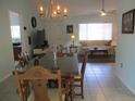 Inviting dining room with tile floors, chandelier, and seamless flow into the living area for easy entertaining at 13779 Sw 115Th Cir, Dunnellon, FL 34432
