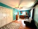 Cozy bedroom with wood floors, a ceiling fan, closet, and neutral-colored walls at 1762 Se 164Th Cir, Ocklawaha, FL 32179