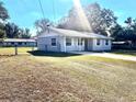 Exterior view of light blue home with well-maintained lawn at 1904 Ne 50Th St, Ocala, FL 34479