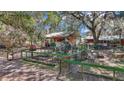 Exterior of property showing the charming backyard with a fenced-in garden area at 19390 Se 95Th Pl, Ocklawaha, FL 32179