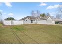 Well-maintained single-story home with a lush front lawn, privacy fence, and attached garage at 2 Hemlock Terrace Trl, Ocala, FL 34472