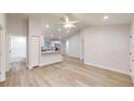 Open concept living space with wood-look flooring leading to a modern kitchen and bathroom at 24264 Sw South Hills Ct, Dunnellon, FL 34431