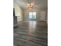 Bright living room features stylish flooring, neutral walls, fan, and a large window at 4721 Nw 67Th St, Ocala, FL 34482