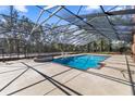 A luxurious screened pool with a connected spa and ample space for relaxation and entertainment at 4940 E Fort King St, Ocala, FL 34470
