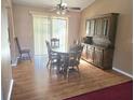 Dining room with wood-look flooring and natural light from sliding glass doors at 5806 Sw 109Th Street Rd, Ocala, FL 34476