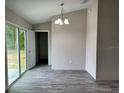 Light filled dining room with new light fixture, with easy access to the patio and backyard at 1 Fisher Lane Way, Ocklawaha, FL 32179