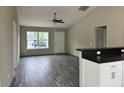 Bright living room with sleek flooring, ceiling fan, granite counter bar, offering comfort and style at 1 Fisher Lane Way, Ocklawaha, FL 32179