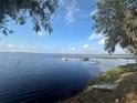 Picturesque lake view with boats docked, clear blue waters, and lush green surroundings on a sunny day at 130 Harbour Cove Way, Clermont, FL 34711