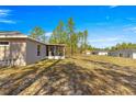 Spacious backyard with a screened-in porch and ample room for outdoor activities at 13057 Sw 85Th Cir, Ocala, FL 34473