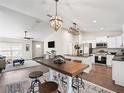 Bright and airy dining area featuring stylish lighting, a large table with seating, and an open floor plan at 14605 Sw 20Th Pl, Ocala, FL 34481