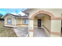 Inviting front entrance with decorative tile walkway, arched entryway, and stylish security door, offering curb appeal at 21353 Sw Beach Blvd, Dunnellon, FL 34431