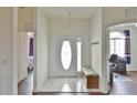 Bright foyer with white door and trim, tile flooring, and bench seating at 2209 Nw 55Th Avenue Rd, Ocala, FL 34482