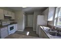 Functional kitchen featuring modern appliances and neutral countertops at 3373 Se 148Th Pl, Summerfield, FL 34491