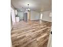 Inviting living room featuring wood floors, a chandelier and a seamless transition to the modern kitchen at 4480 Ne 25Th Ave, Ocala, FL 34479