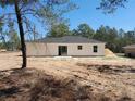 View of the back of the house showing the sliding glass door and outdoor patio at 46 Malauka Dr, Ocklawaha, FL 32179