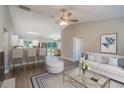 Open-concept living area with barstool seating and a view into the bright and airy dining space at 46 Malauka Dr, Ocklawaha, FL 32179