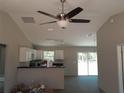 Open concept living area with ceiling fan, tile flooring, and a large sliding glass door at 46 Malauka Dr, Ocklawaha, FL 32179
